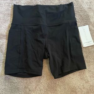 Womens Athleta Salutation Stash Pocket ll 7” short. Size M. Color: black. BNWT